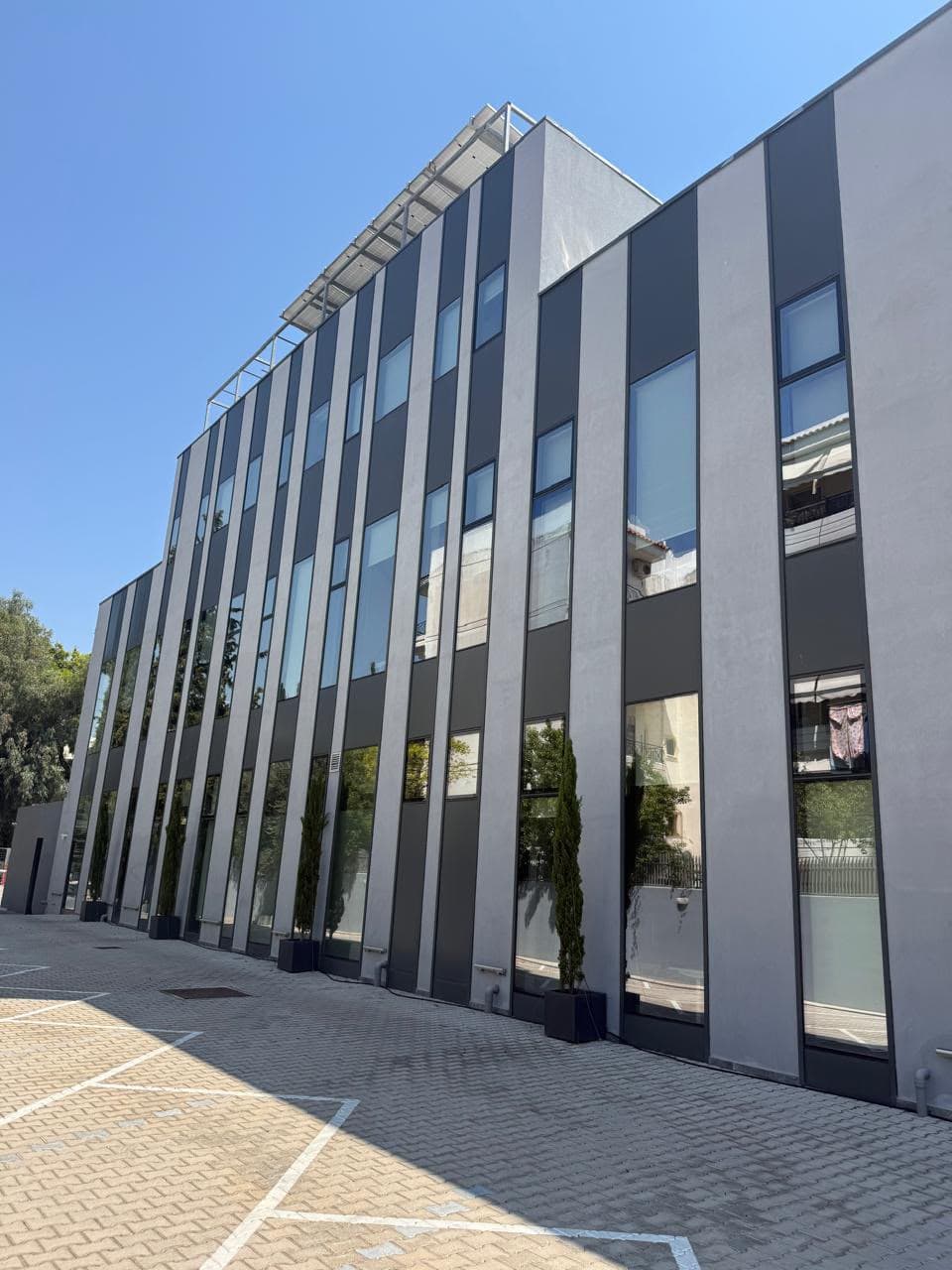 The glazed elevation running the length of the parking court.
