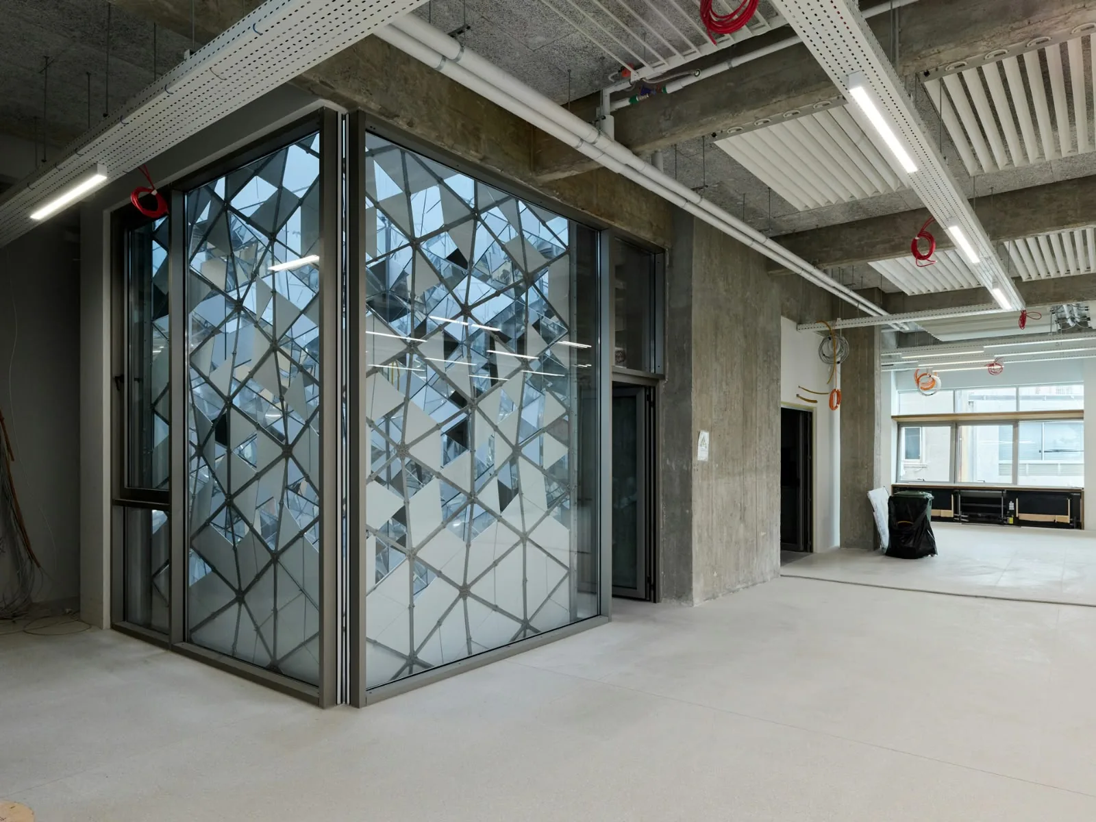 The faceted glass of the atrium, from an open floor before fit-out.