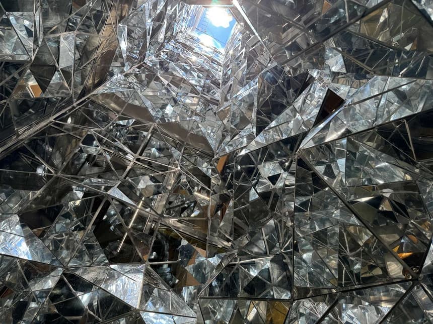 The faceted mirrored glass that lines the atrium.