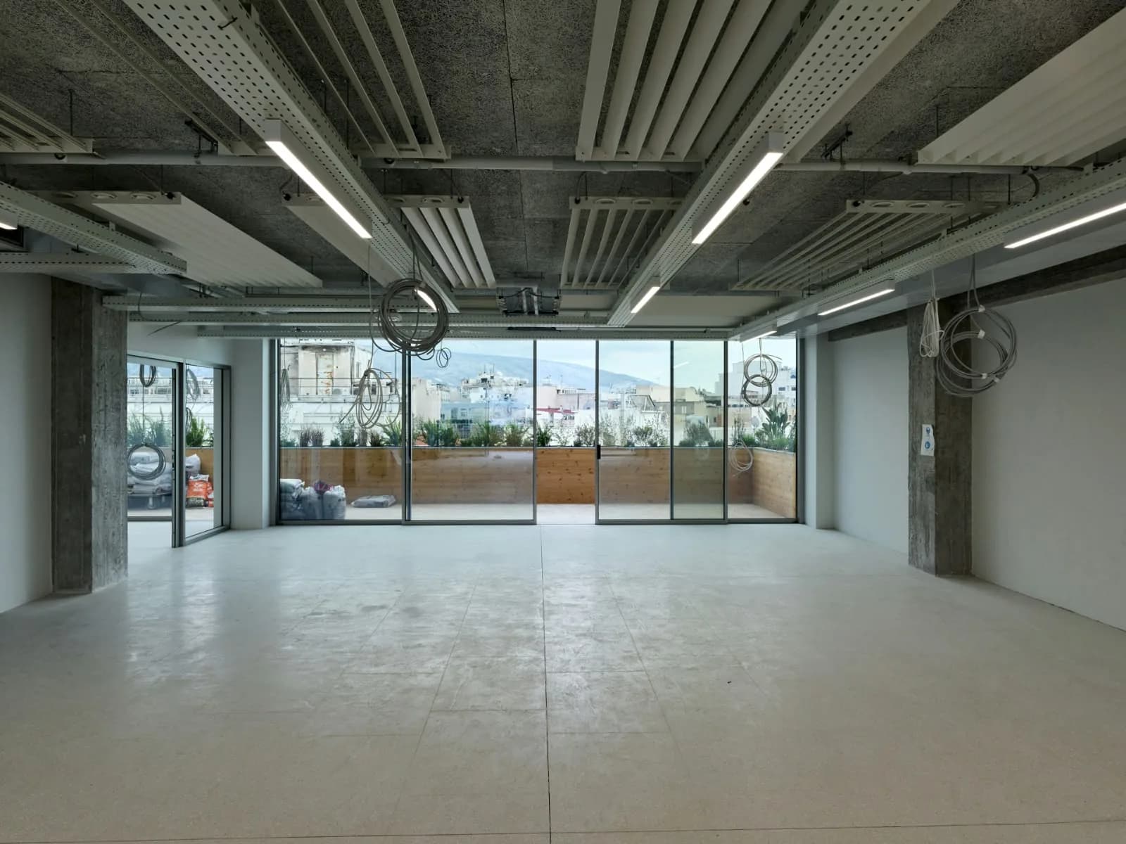 An open floor running out to a planted terrace.