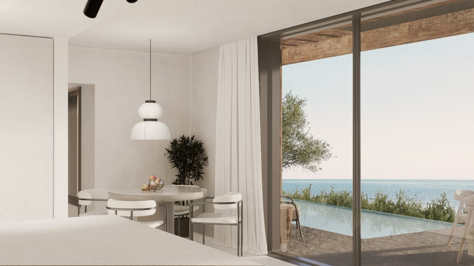 Living and dining space opening to the terrace and the sea.