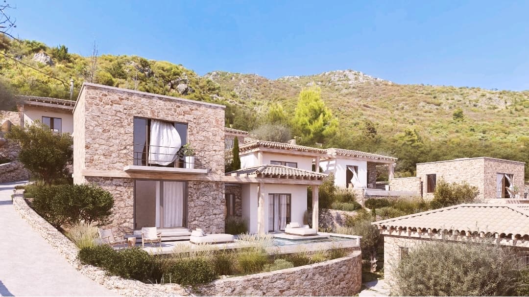 Stone and rendered elevations stepping up the hillside.