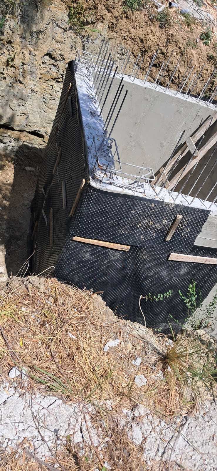 Waterproofing and drainage to the retaining wall.
