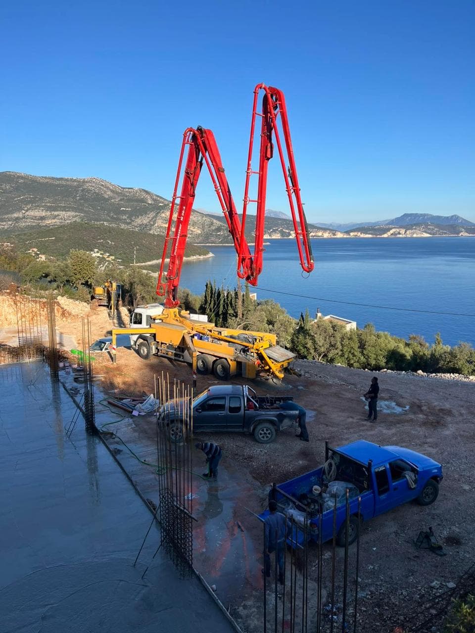 Concrete pour on site, with the Ionian beyond.